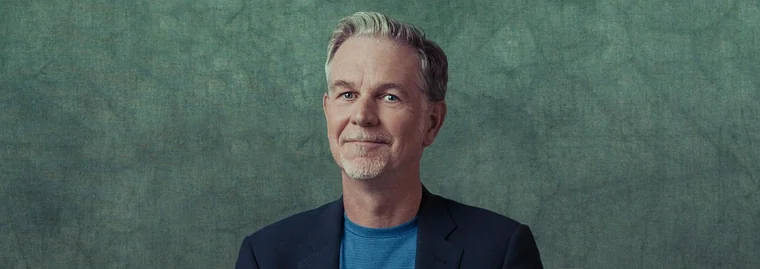 Portrait of Reed Hastings against a green backdrop