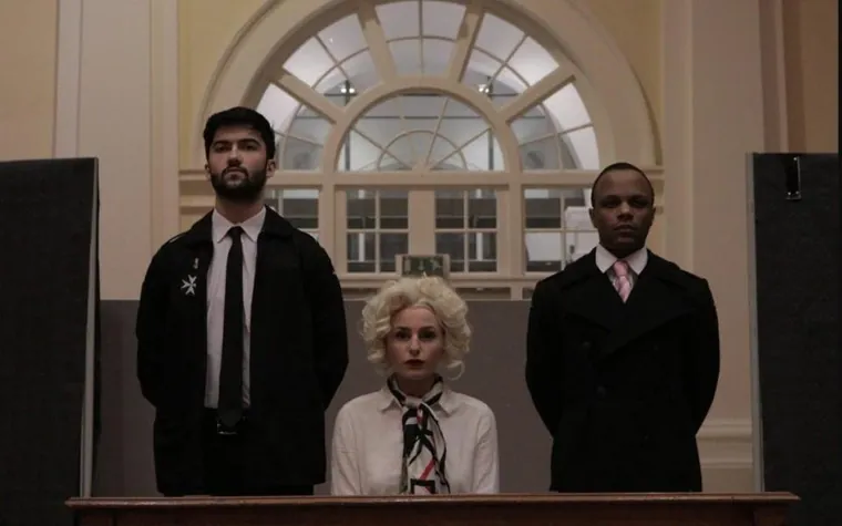 The defendant in the dock at The Accused, a 1950s courtroom