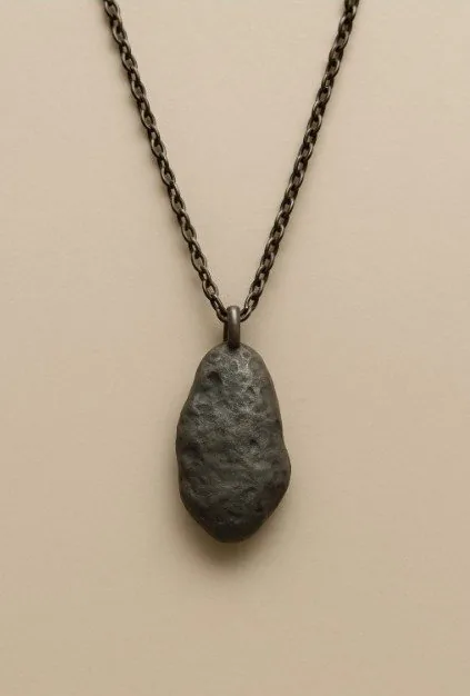 Rendering: a dark stone pendant on a black chain