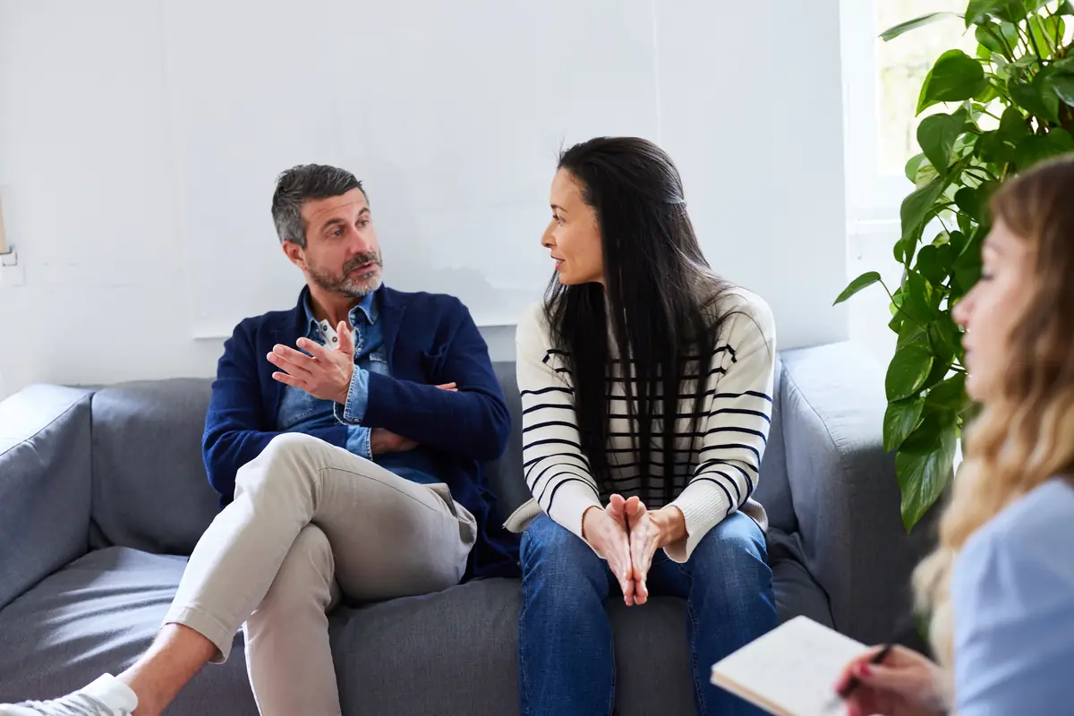 Two colleagues talking on a sofa during a facilitated session