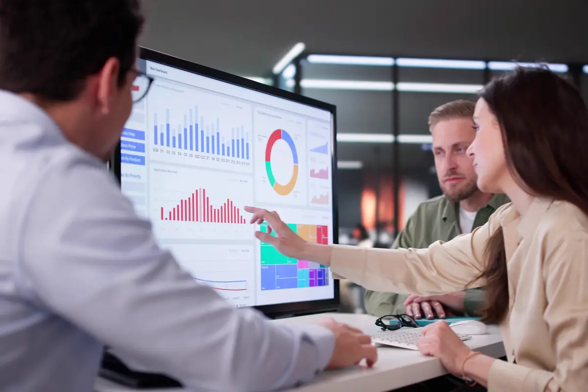 A colleague pointing at a dashboard during a review