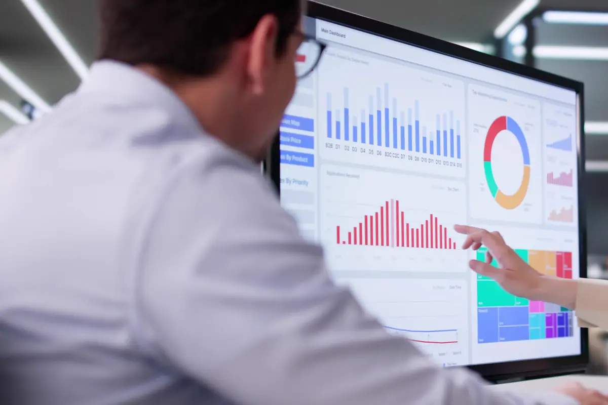 A colleague pointing at a dashboard during a review: the row that gets collected is not the row that counts