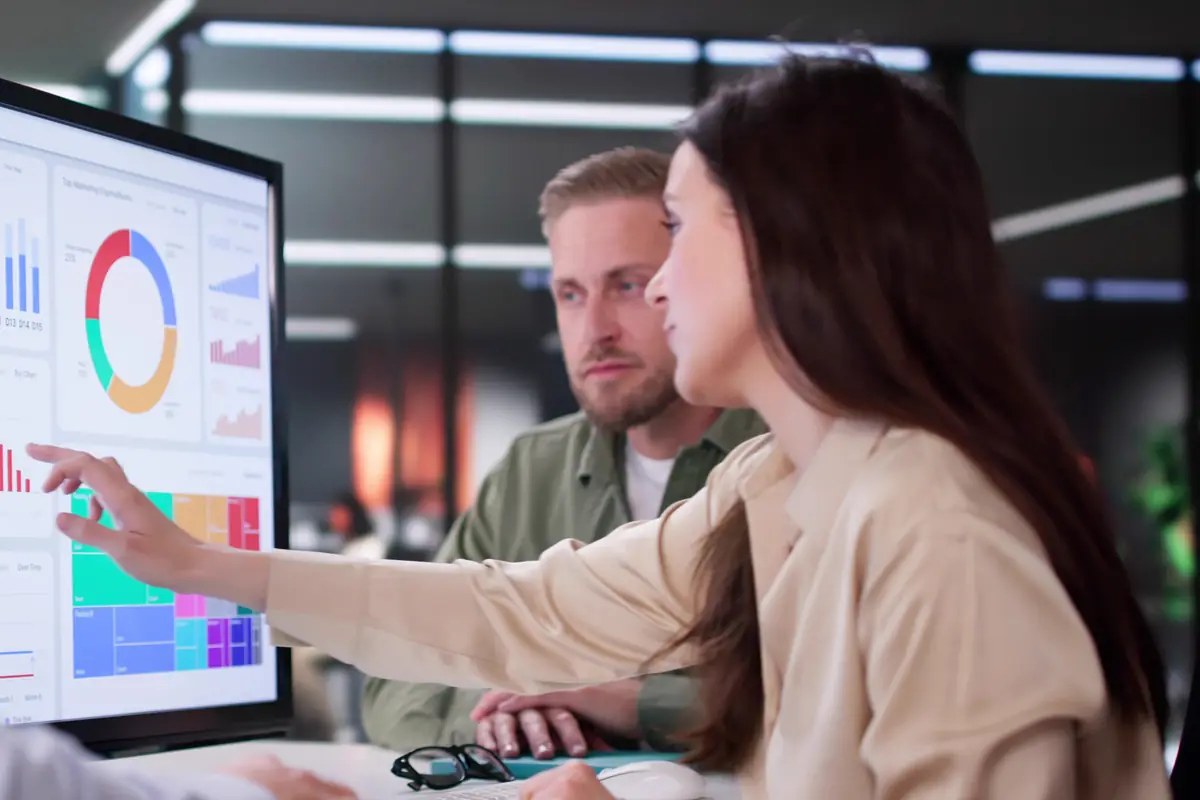 A colleague pointing at a data dashboard