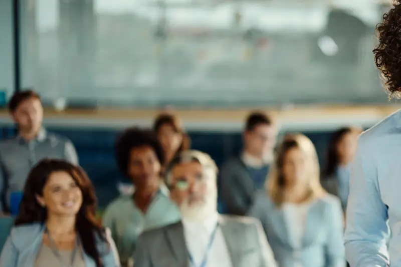 An audience of colleagues listening at an event