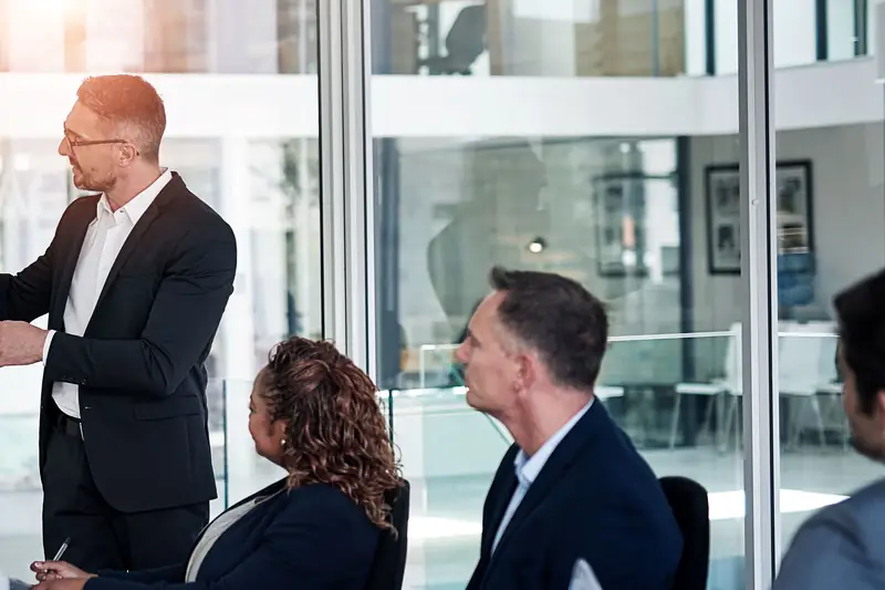 A leader presenting to a team at a whiteboard
