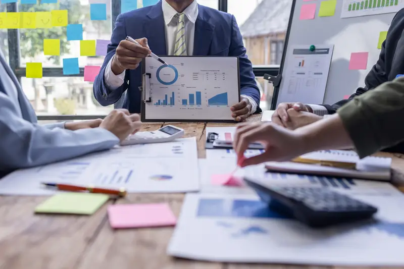 Charts and sticky notes spread across a planning table