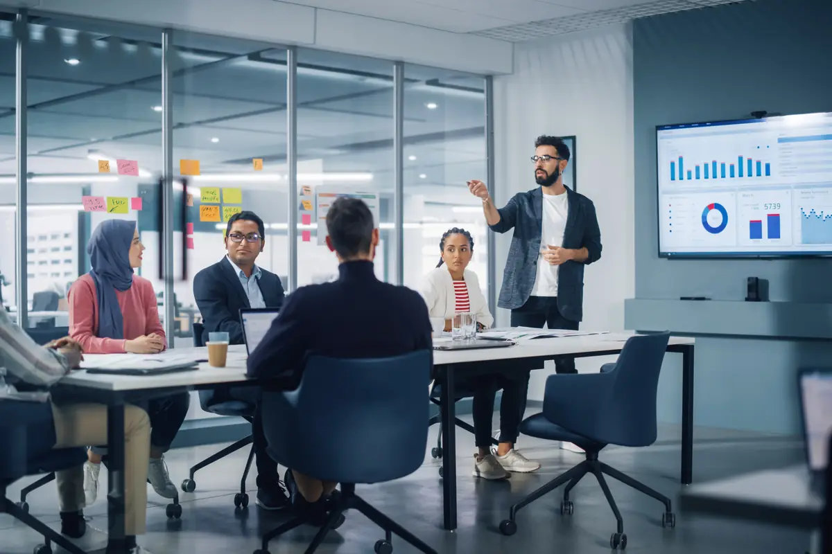 A presenter walking a team through a dashboard