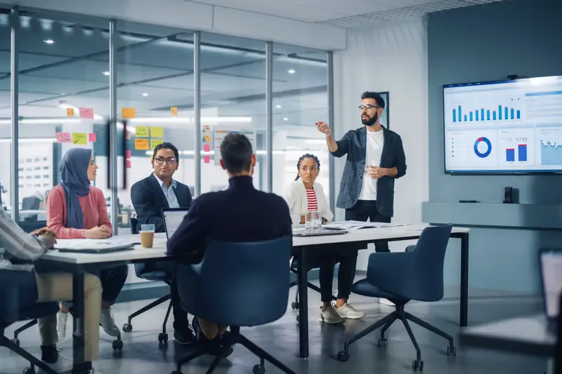 A presenter walking a team through a dashboard